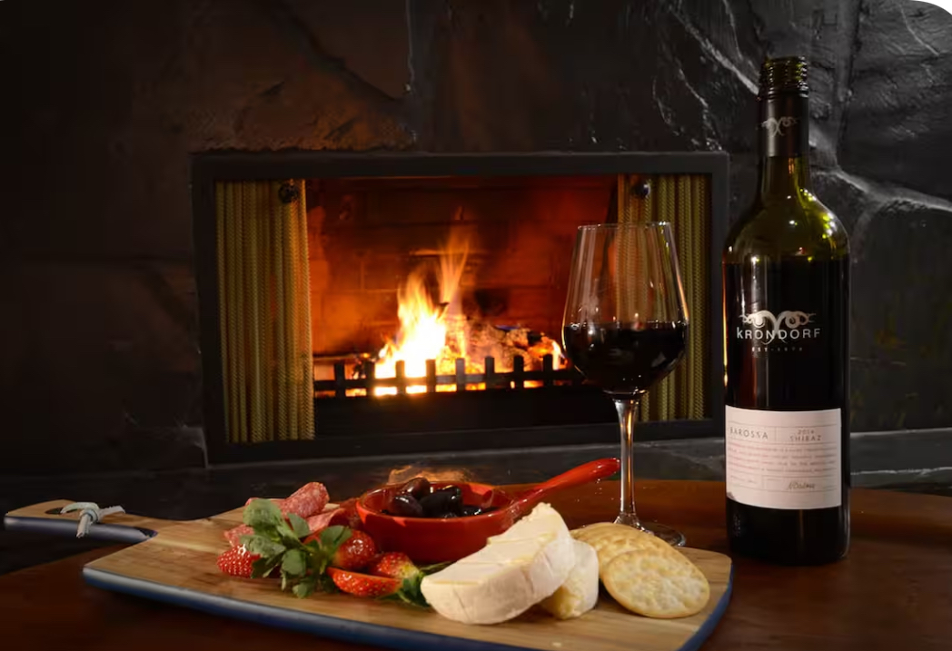 Cosy fireplace with wine and grazing board