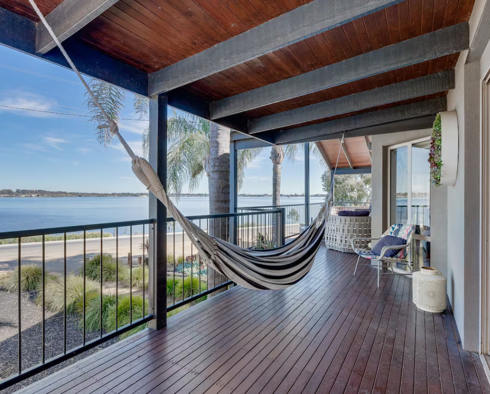 Lakefront balcony with hammock at Paradise Waters